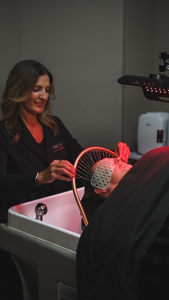 Carisa guiding a red light scalp therapy session at the halo basin